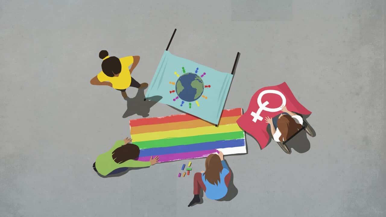 Women making gay pride posters