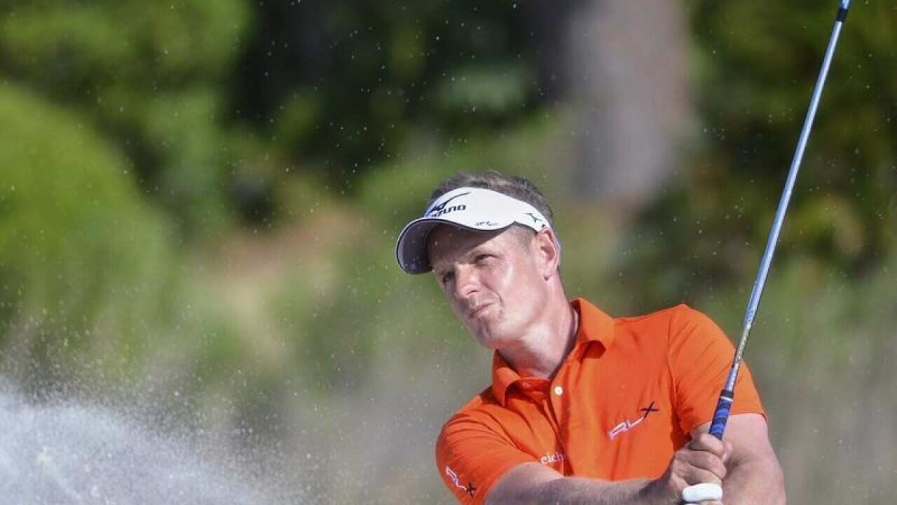 Luke Donald hits out of a bunker