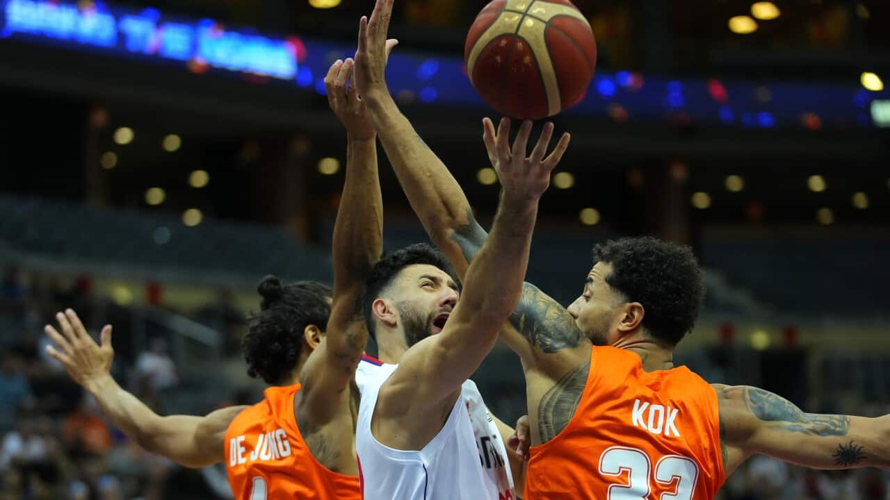 Worthy de Jong of Netherlands, left, and Jito Kok of Netherlands, left, challenge Serbia's Vasilije Micic during the Eurobasket group D basketball match between Serbia and Netherlands in Prague, Czech Republic, Friday, Sept. 2, 2022.