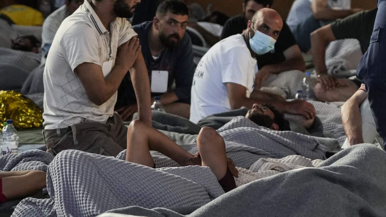 Survivors of the shipwreck rest in a warehouse at the port in Kalamata town, southwest of Athens.
