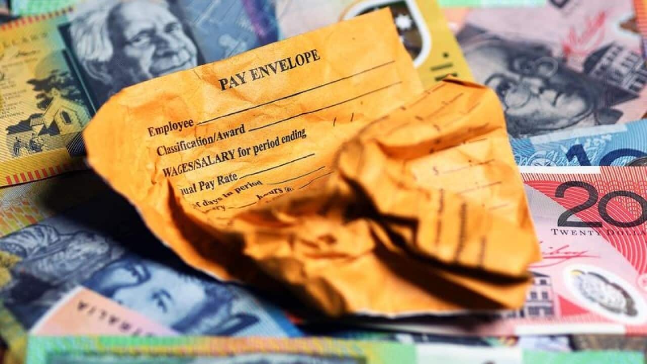 This is a file stock image of a pay envelope on top of money.