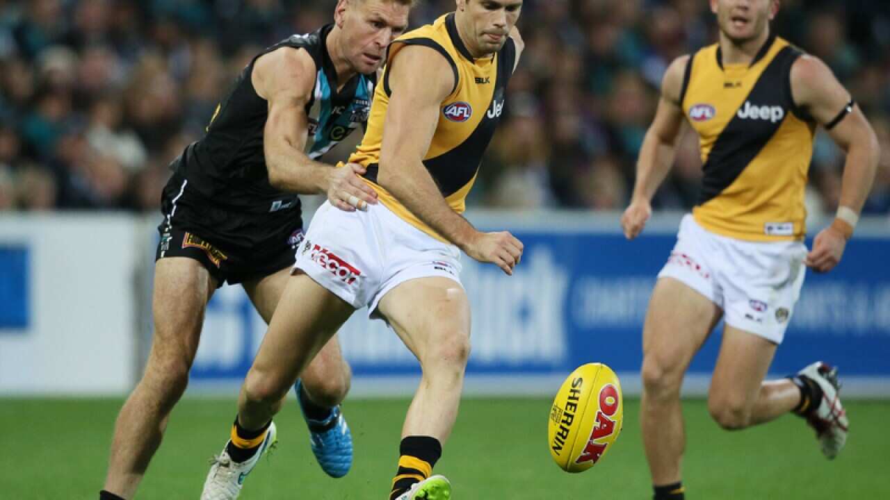 Trent Cotchin out paces attack from Kane Cornes