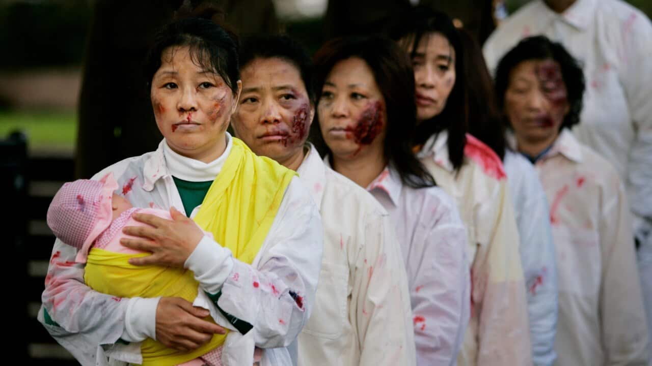 A file photo of protesters opposed to the Chinese authorities acting out alleged atrocities against Falun Gong members in Sydney, September, 2007.