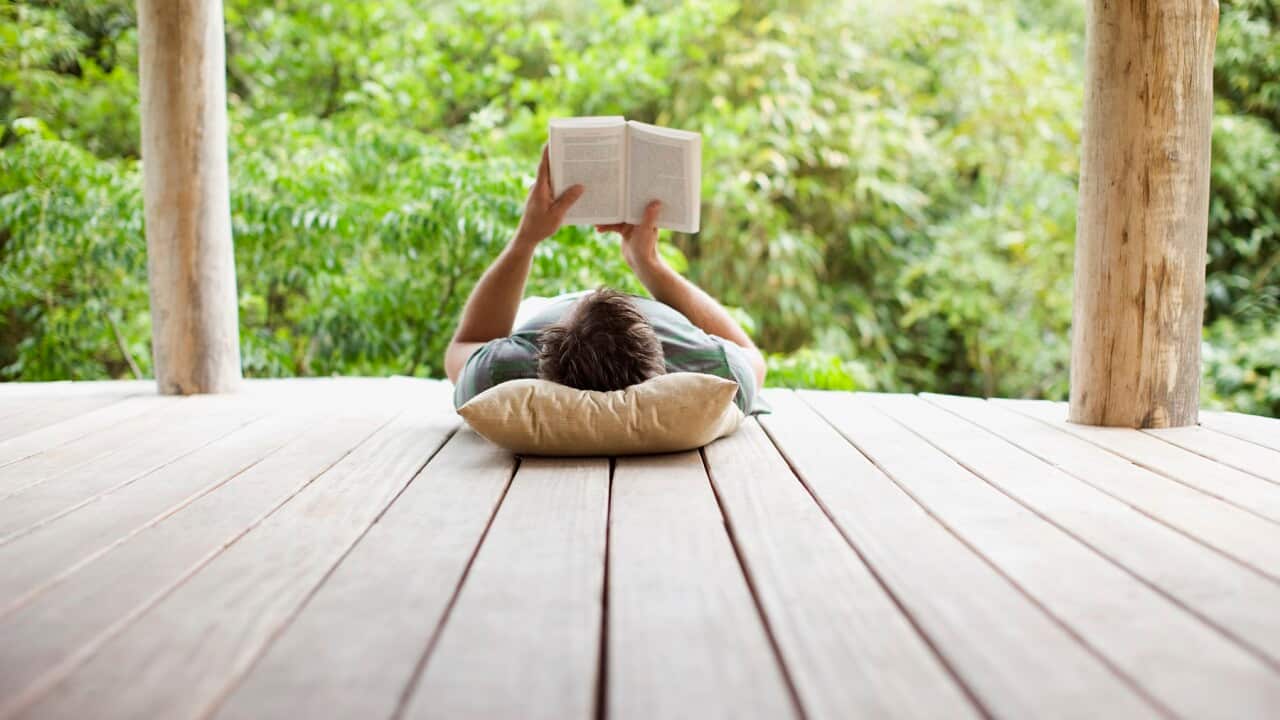 Man reading on porch in remote area