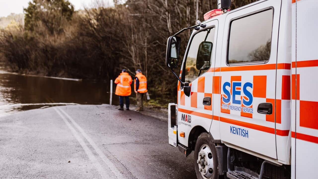 A truck stops at a flooded rood.