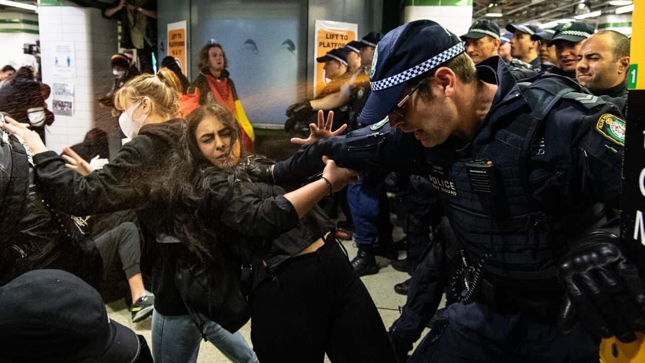 Police spraying protesters with pepper spray inside Central Station after a Black Lives Matter rally in Sydney, Saturday, June 6, 2020.