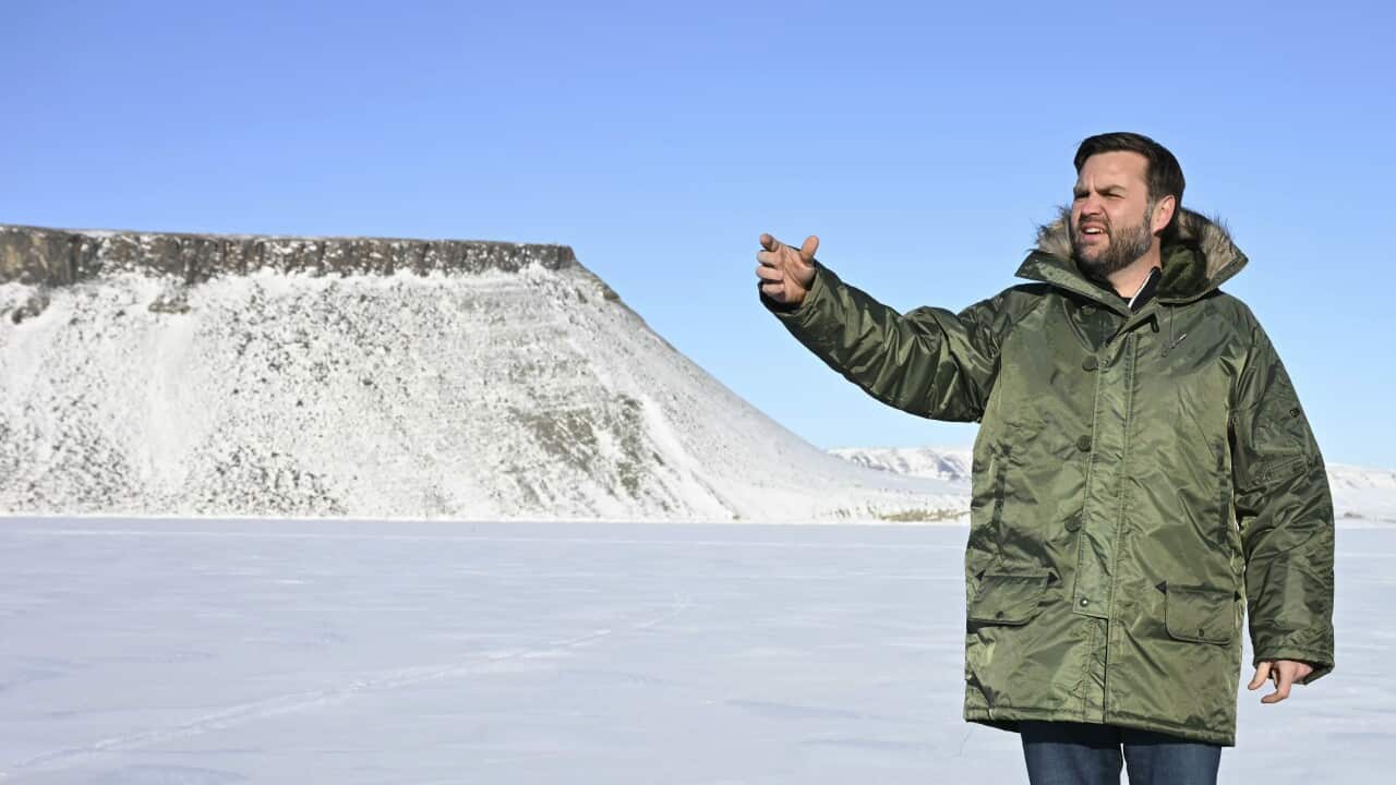 Vice President JD Vance gestures as he tours Pituffik Space Base - a large white expanse of snow