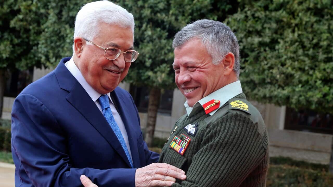 Jordan's King Abdullah II, right, welcomes Palestinian President Mahmoud Abbas to the Royal Palace, in Amman.