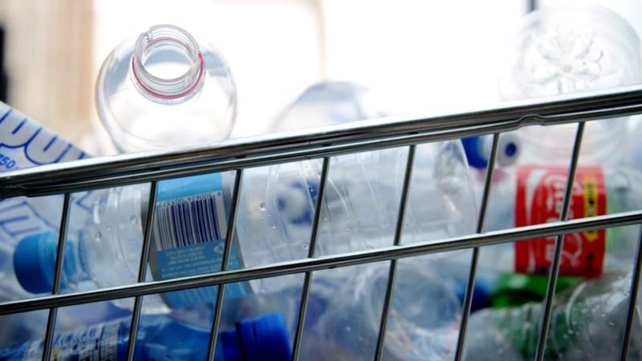 Empty plastic bottles are packed into trolleys