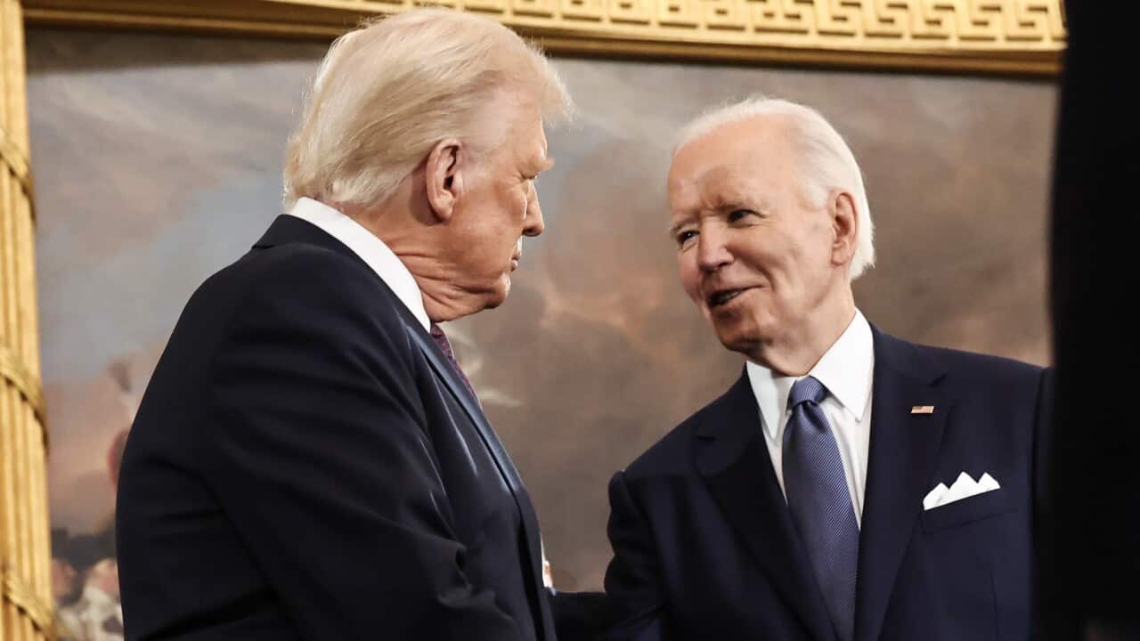 Donald Trump and Joe Biden shake hands.