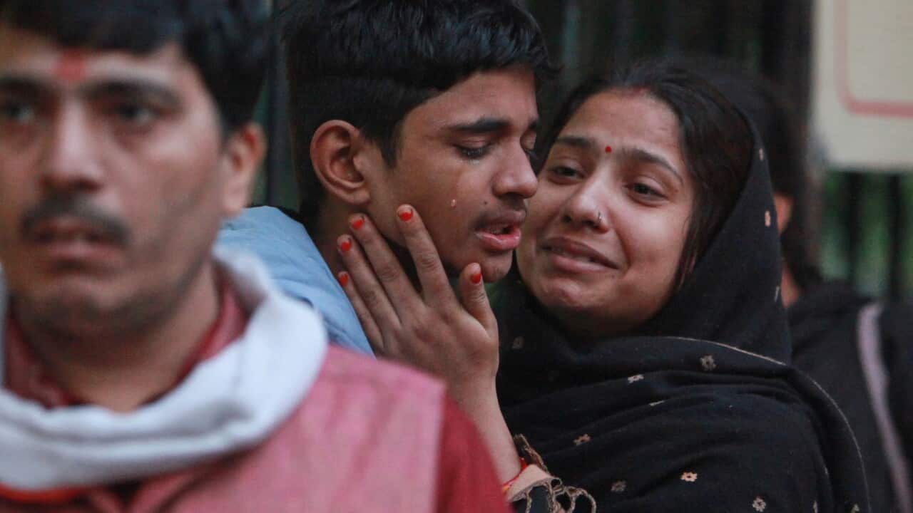 Family members of a car explosion victim grieve as they arrive at a hospital mortuary to collect the body in New Delhi