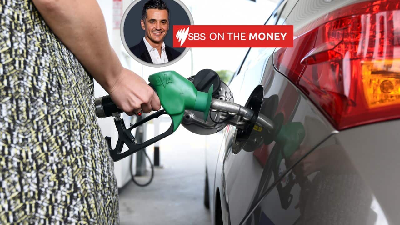 A female customer tops up the petrol levels for her car. 