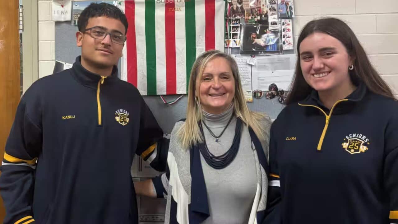 Teacher Silvia De Cesare (center) with Kanuj Sehgal (left) and Clara Rehill (right) at her side.
