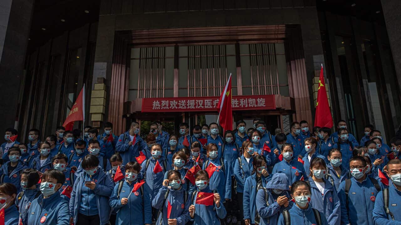 Chinese medical workers from Shandong province take part in a ceremony before leaving Wuhan.