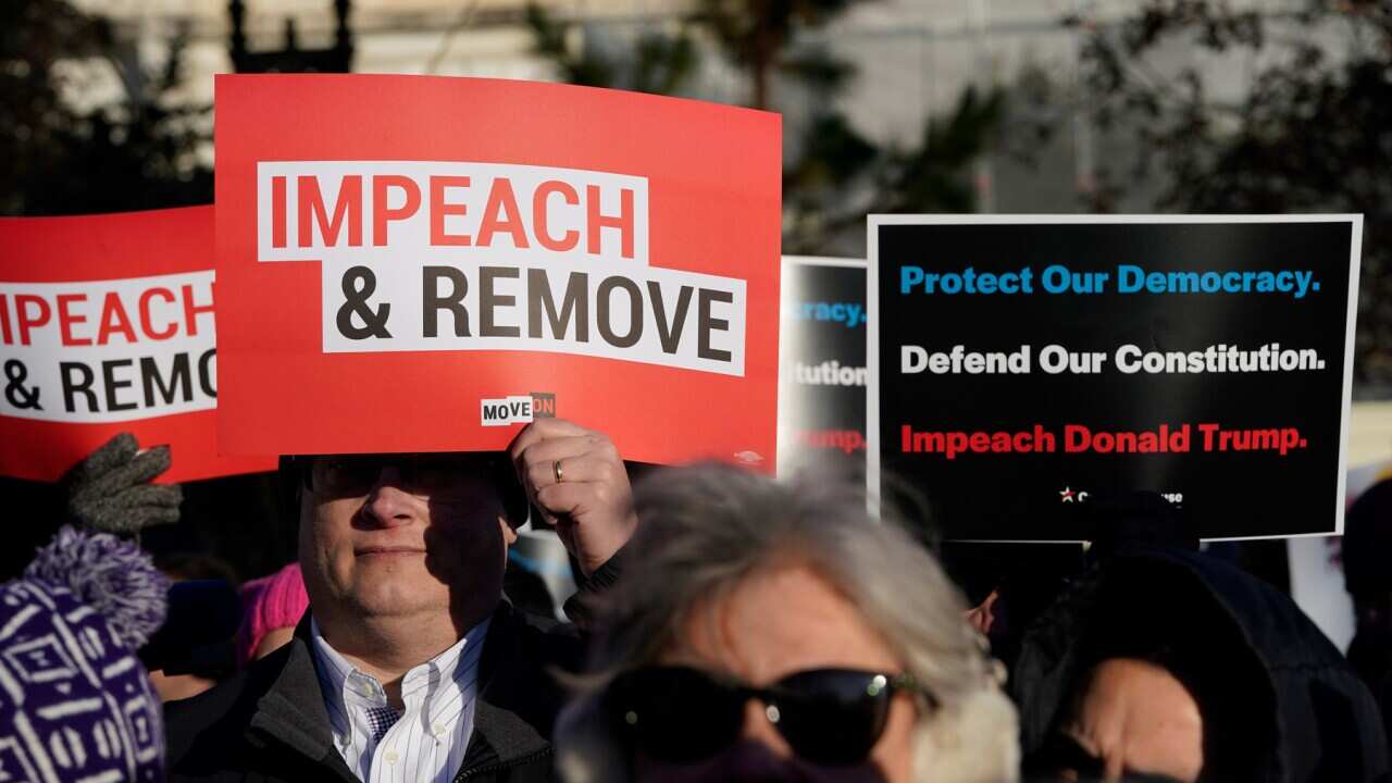Protesters supporting the impeachment of US President Donald Trump outside the Capitol