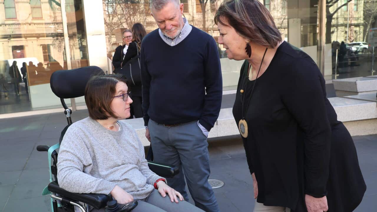 A woman and her parents outside a Royal Commission hearing (AAP).