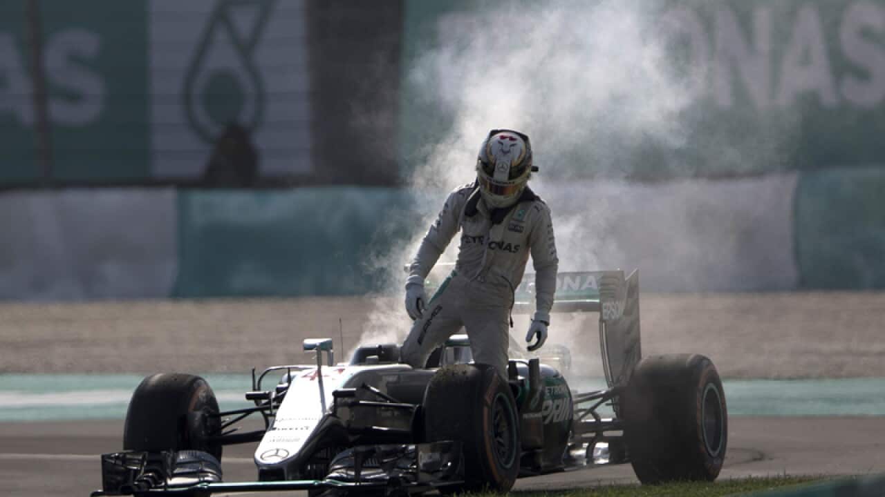 Lewis Hamilton leaves his car after an engine failure