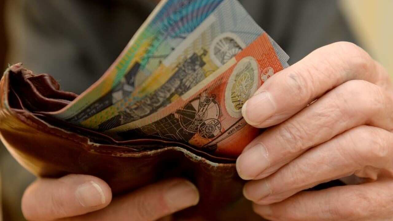 Money is taken out of a wallet.