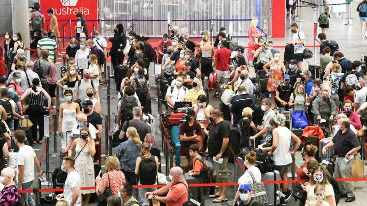 Passengers check in for flights out of Brisbane on Monday. Greater Brisbane will enter a snap three-day lockdown as its coronavirus outbreak continues to grow.