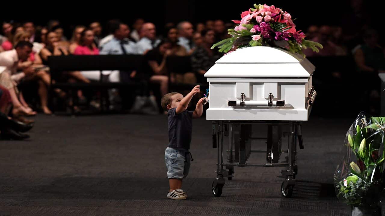 Hannah Clarke's nephew Tyler reaches to the coffin during the funeral for Hannah and her three children Aaliyah, Laianah and Trey in Brisbane.