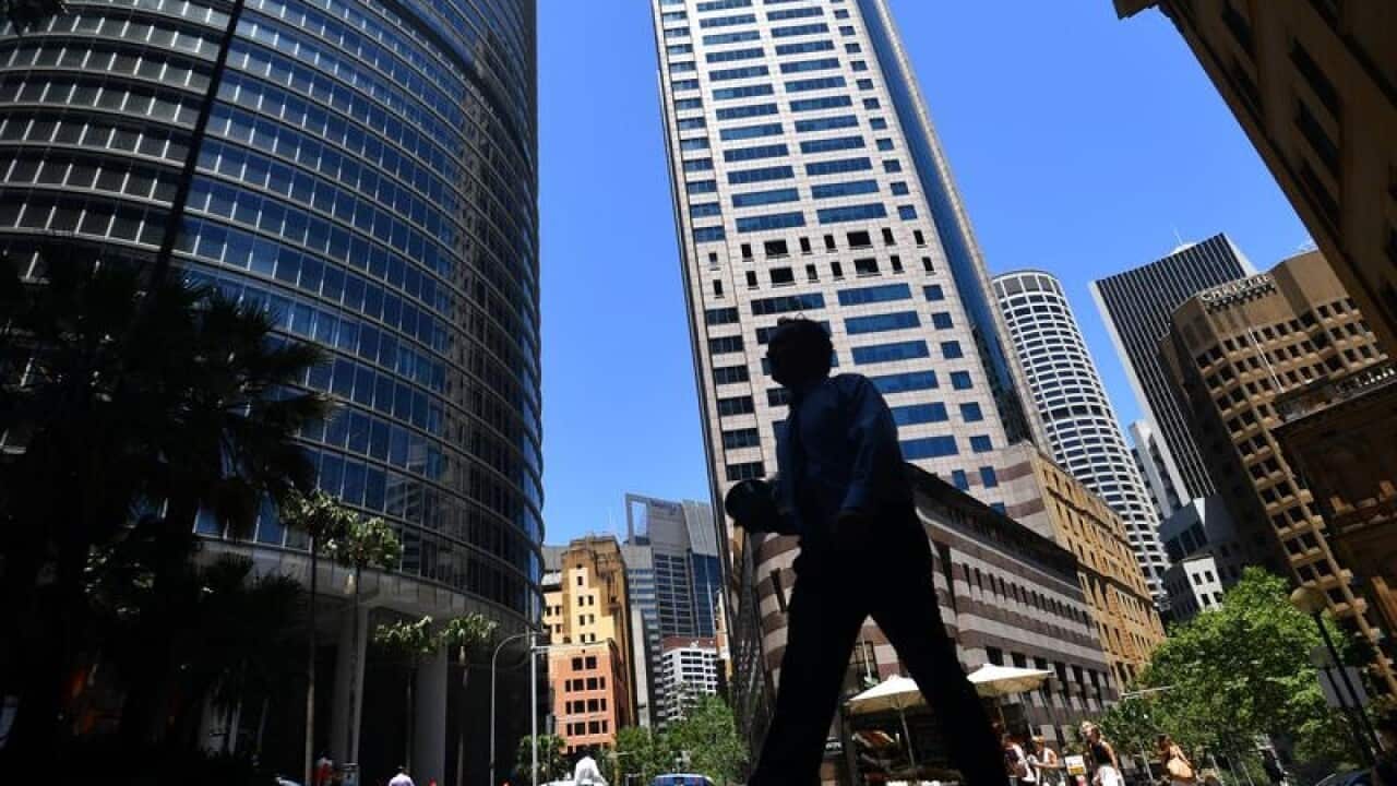 An office worker is seen in the Sydney CBD