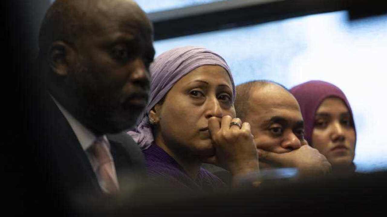 Representatives of the Rohingya community and Gambia's Justice Minister Aboubacarr Tambadou, left, listen to testimony during a press conference in The Hague