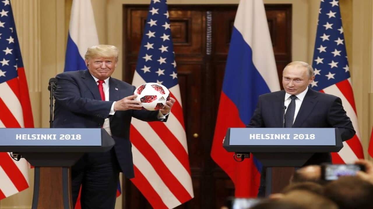 Donald Turmp receives a soccer ball from Vladimir Putin
