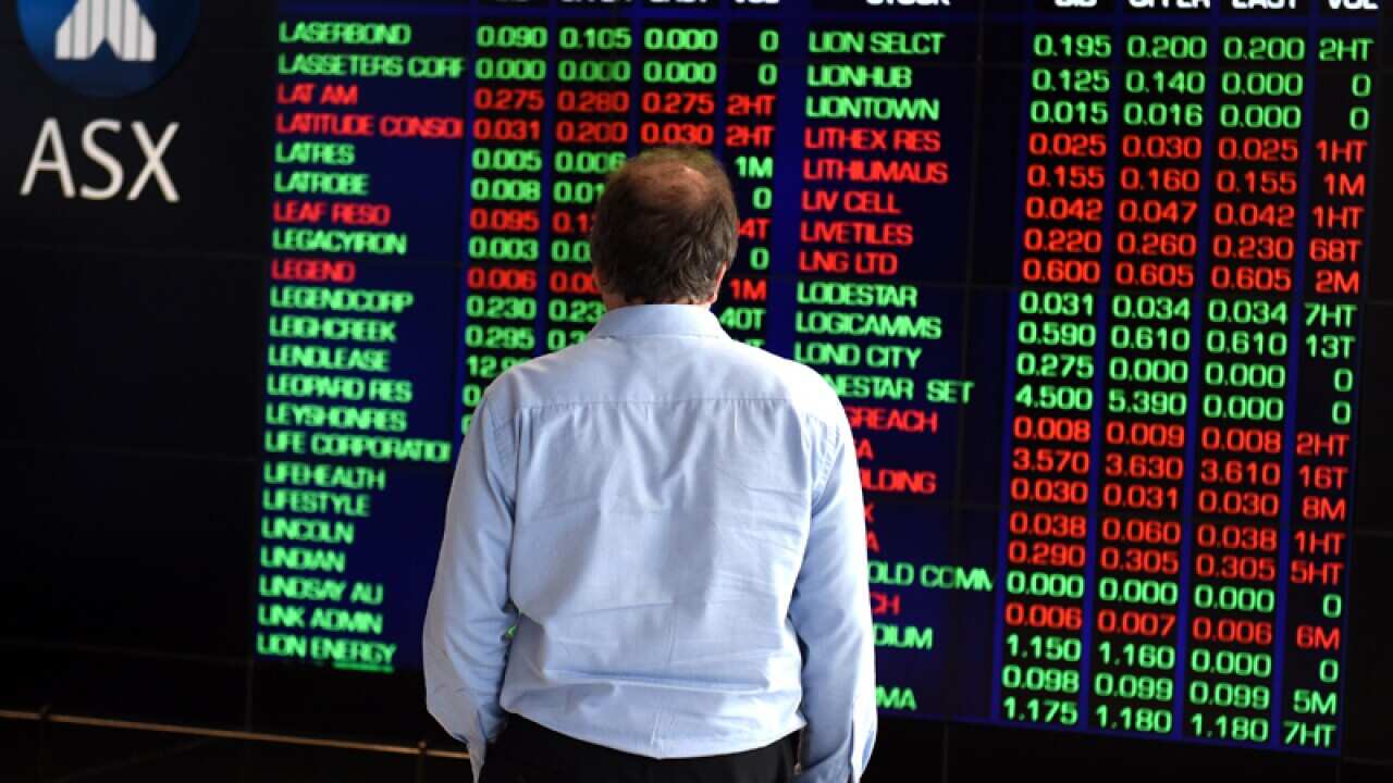A man watches the shares prices listed at the ASX, Sydney