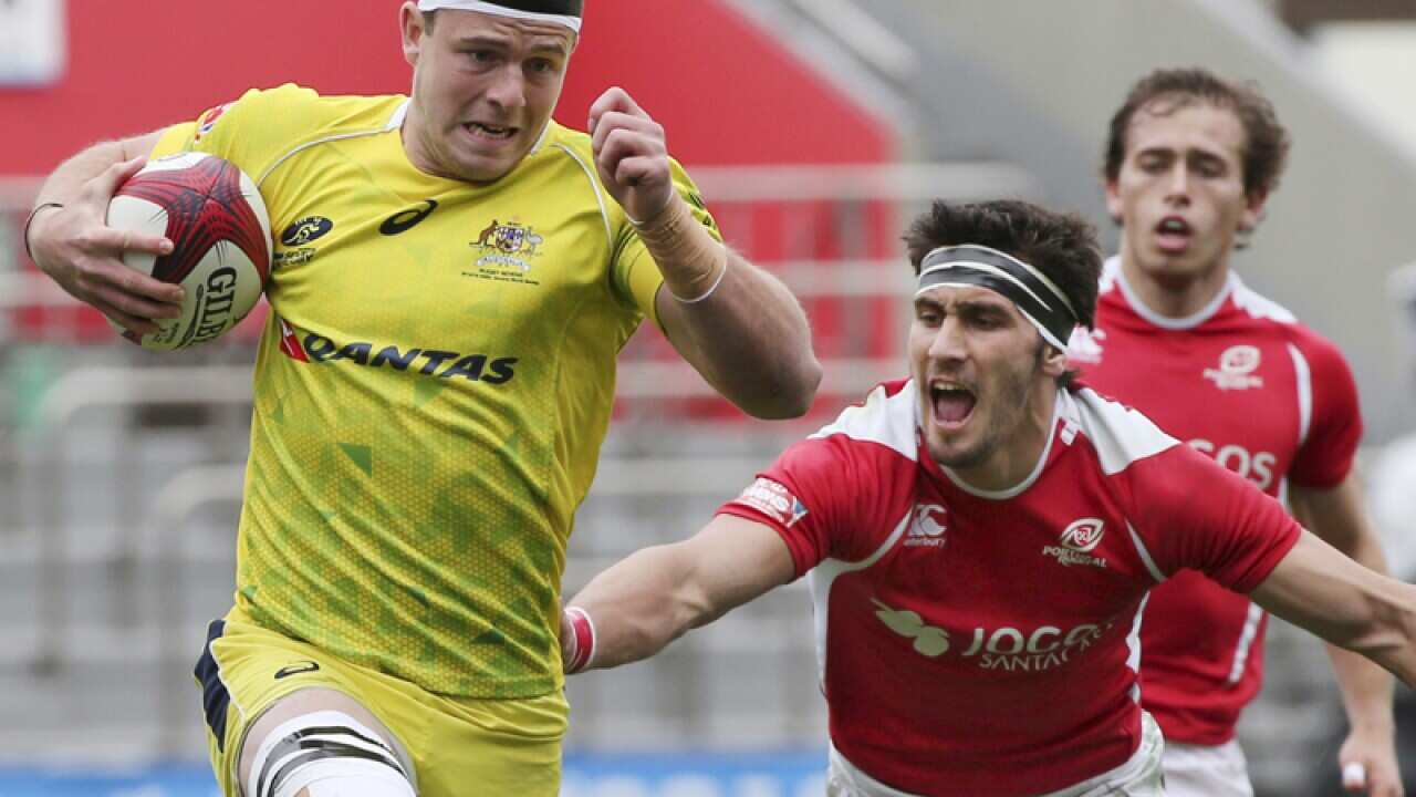Australia's Nick Malouf (L) is tackled by Portugal's Jose M. Vareta