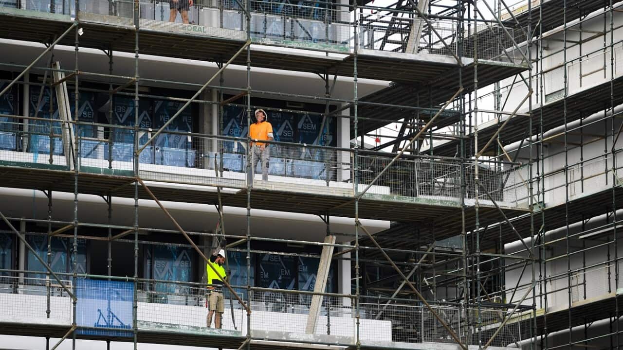 Workers are seen at a construction site in Canberra, Thursday, March 17, 2022.