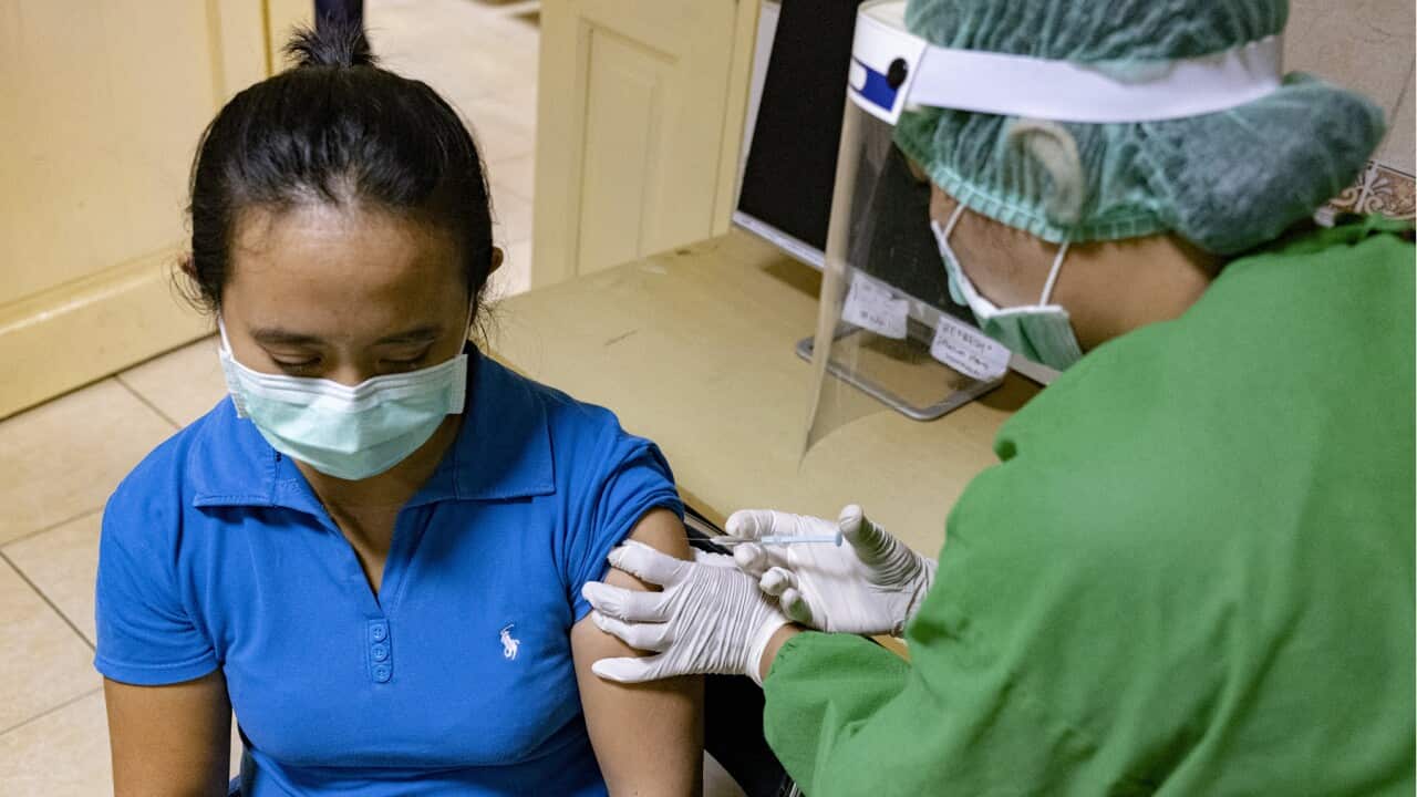 A medical worker takes part in a vaccine drill in Indonesia (AAP)