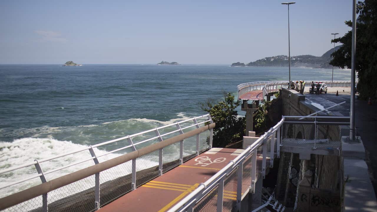 A bike lane is missing a section after it collapsed onto the beach below in Rio de Janeiro, Brazil, Thursday, April 21, 2016.