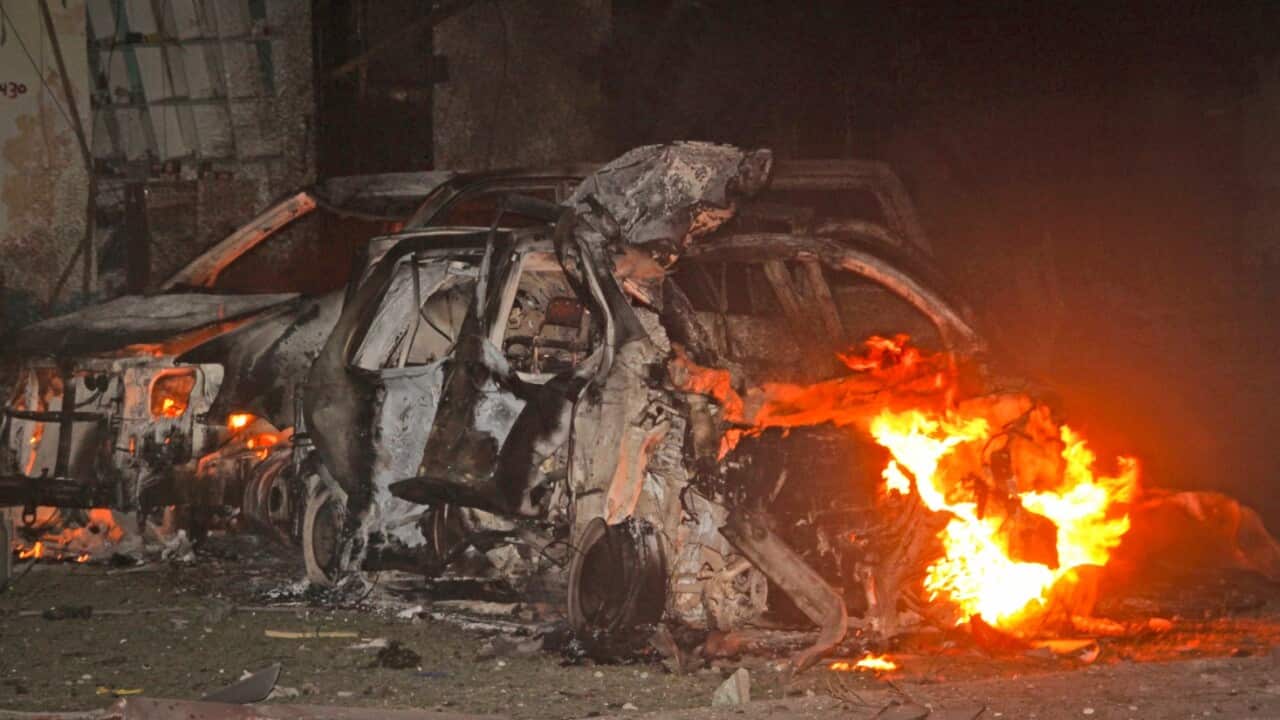 Vehicles burn at the scene a bomb attack on an hotel in Mogadishu, Somalia Wednesday, June 1, 2016. 