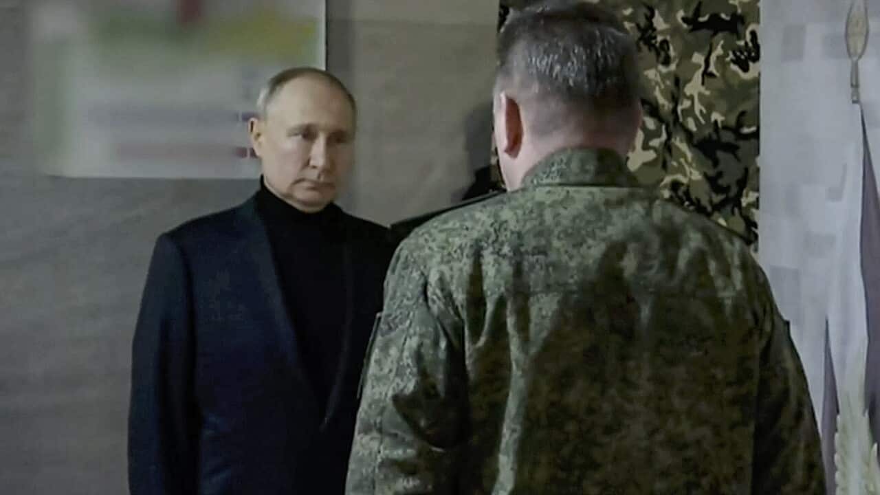 Russian President Vladimir Putin facing a Russian soldier