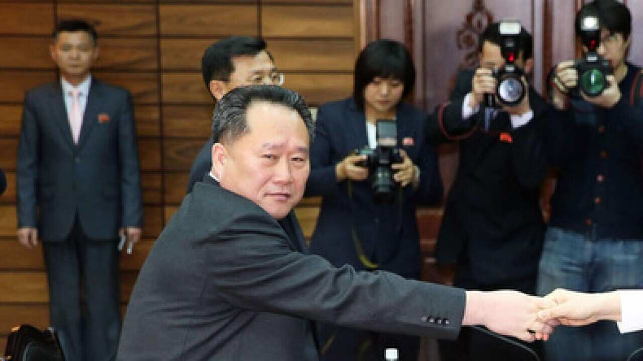 South Korean Unification Minister Cho Myoung Gyon (R) and Ri Son Gwon, chairman of North Korea's Committee shake hands.