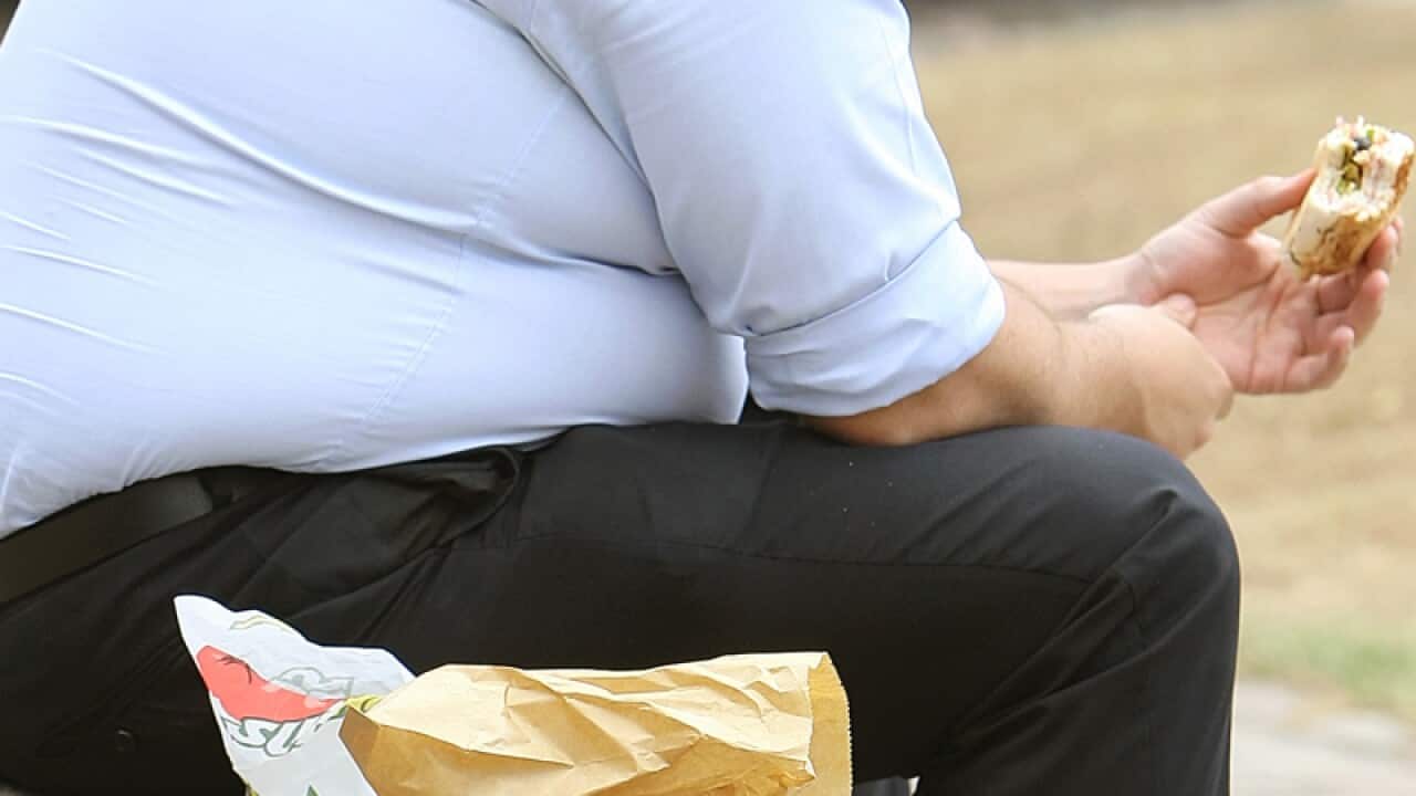 An overweight man eating
