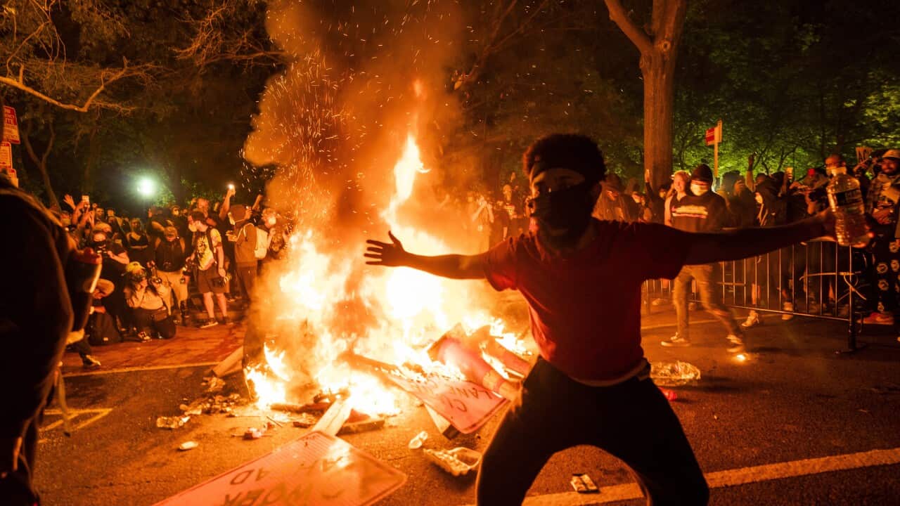Protesters gather around a fire outside the White House