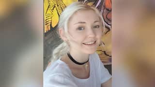 A young blonde woman with her hair tied back