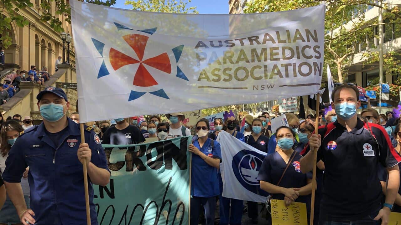 Paramedics are seen marching with nurses in Sydney, Tuesday, February 15,
