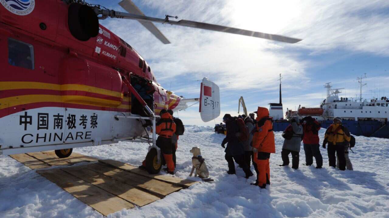Passengers from the trapped Russian vessel board a Chinese helicopter