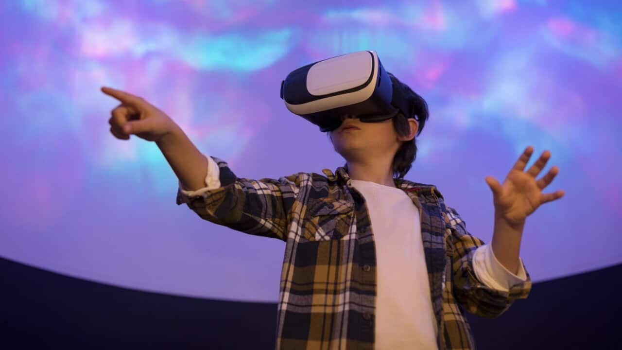 Boy using virtual reality simulator