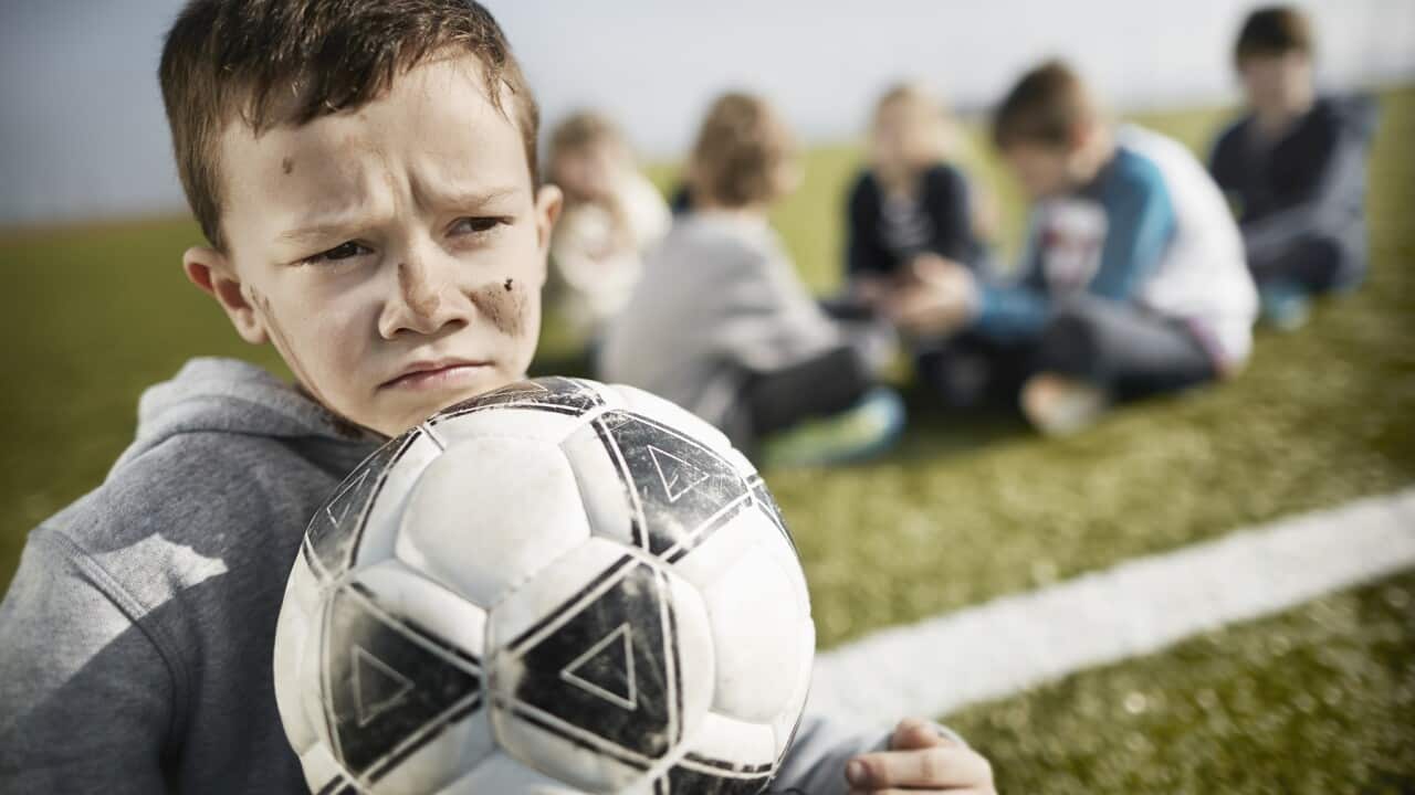 Boy with dirty face on soccer field