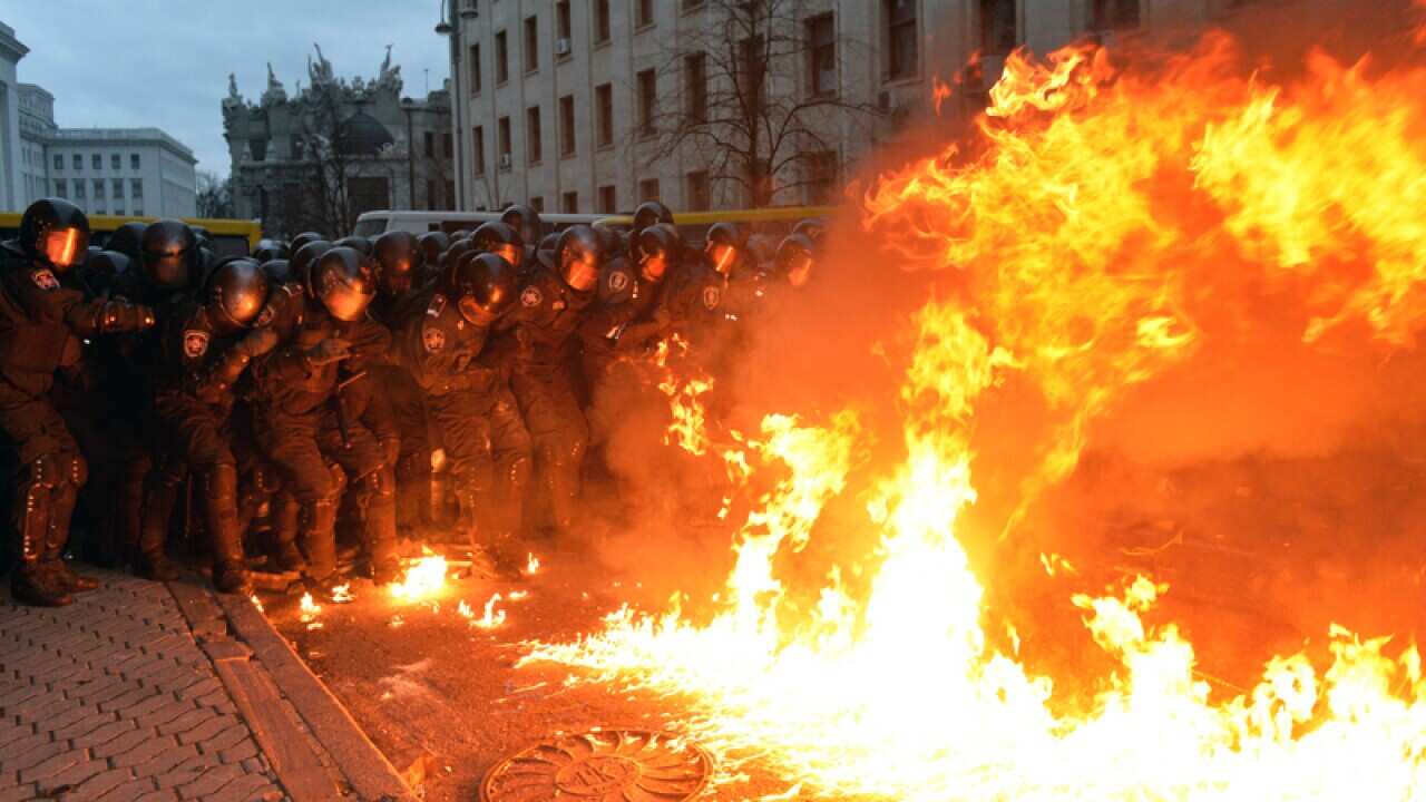 A molotov cocktail explodes in front of police in Kiev