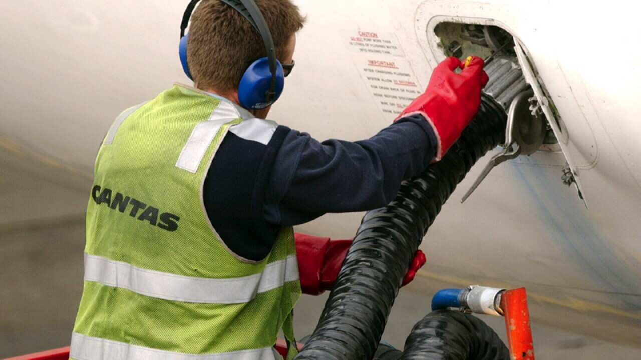 A Qantas worker refuels