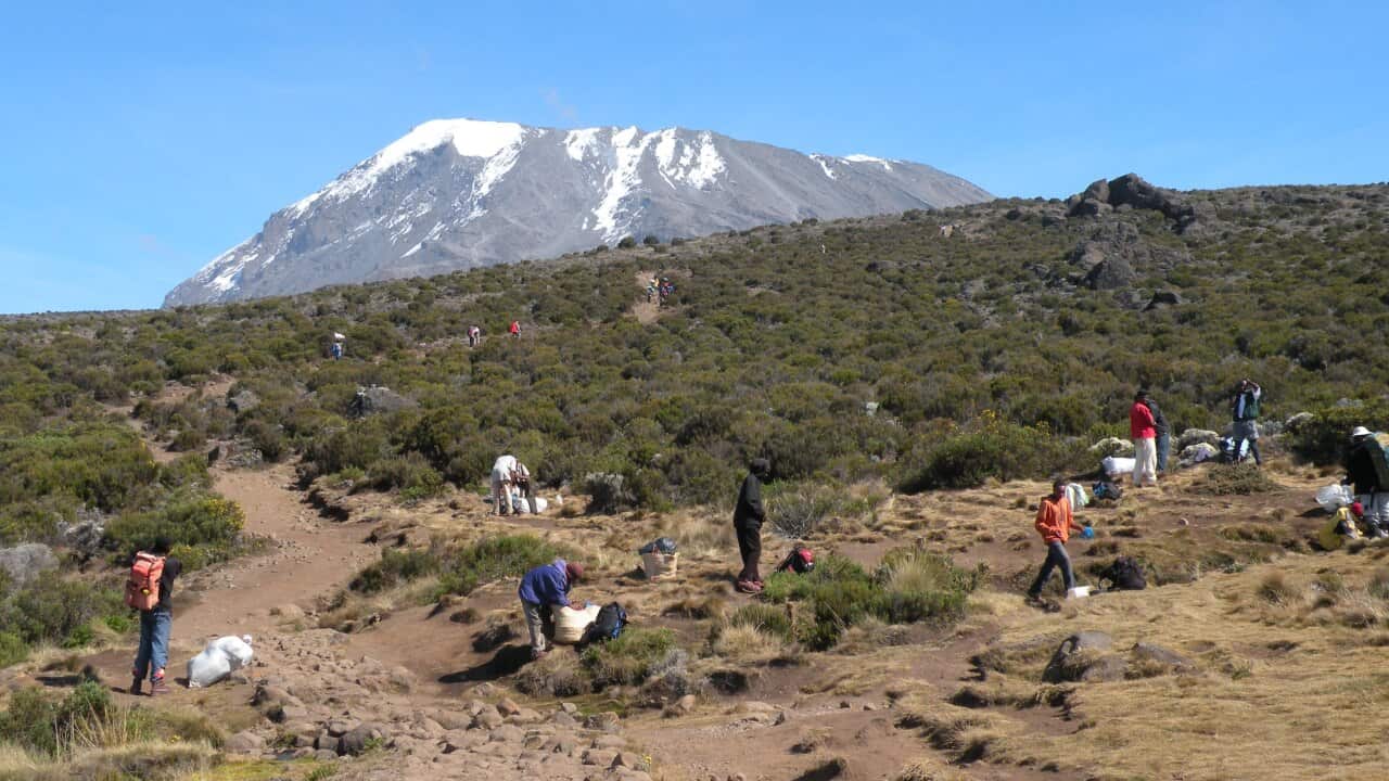 Porters stop for a break on the ascent to Kibo hut.