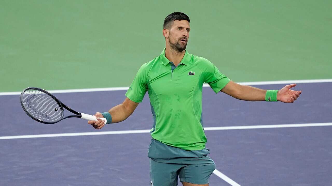 Novak Djokovic, of Serbia, reacts after losing a point against Luca Nardi, of Italy, at the BNP Paribas Open tennis tournament in Indian Wells