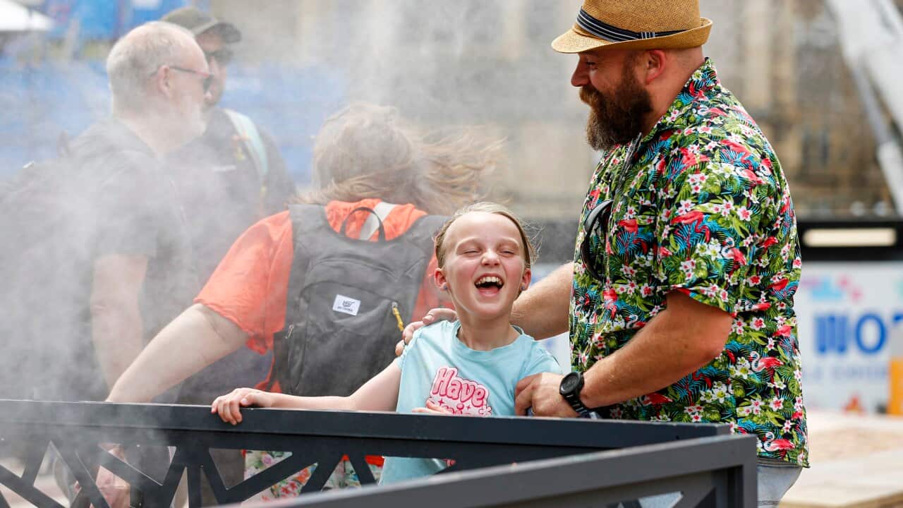 People enjoy mist cooling fans in Melbourne on a 43 degree day (AAP)