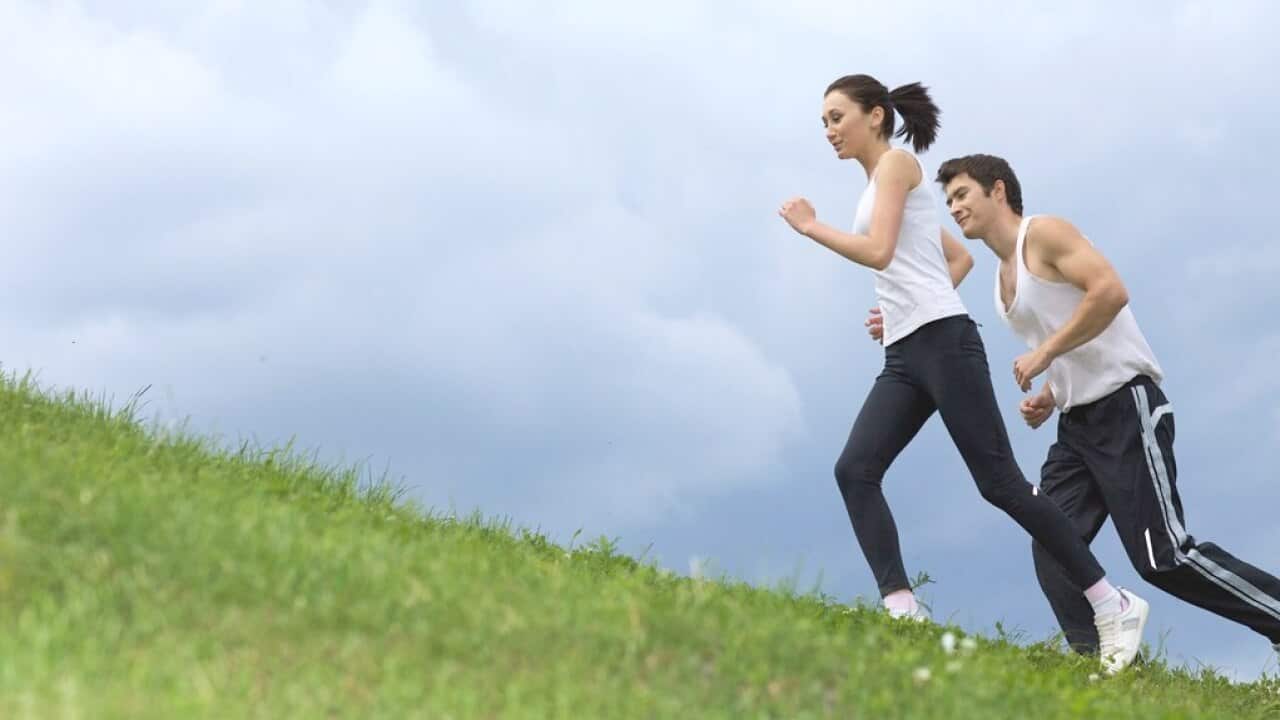 Young couple exercising in park