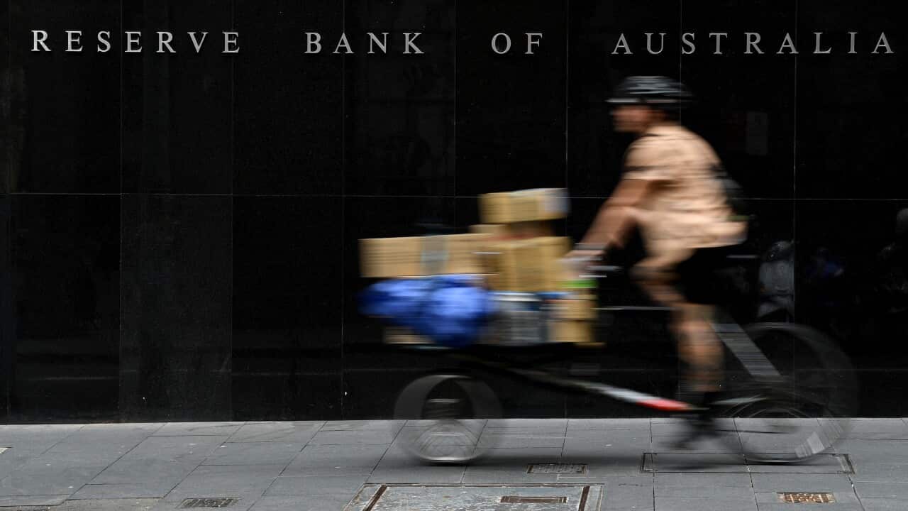 A bike moving past the Reserve Bank of Australia building.