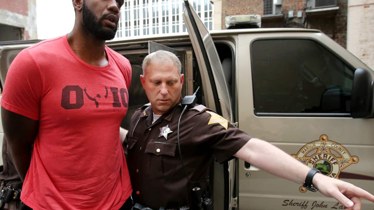 Greg Oden is escorted into a County Community Corrections building.